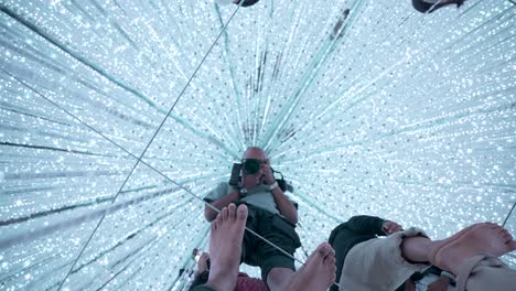 POV-Of-Male-Filming-Mirror-Floor-At-Teamlab-Planets-At-The-Infinite-Crystal-Universe-Room