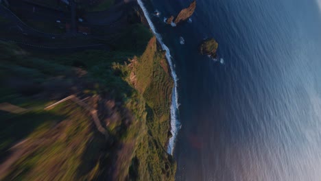 FPV-drone-dive-from-a-mountain-top-to-the-ocean-at-the-coast-of-Madeira