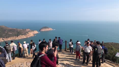 Groups-of-tourists-take-photographs-at-the-Biu-Tsim-Kok-viewing-point-in-San-Kung-East,-Hong-Kong