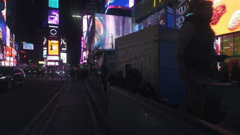POV-shot-biking-in-middle-of-people-at-Times-square,-night-in-Manhattan,-New-York