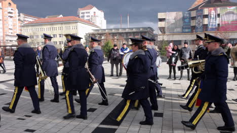 Military-band-marches-in-parade-through-courtyard-in-Miercurea-Ciuc,-Romania