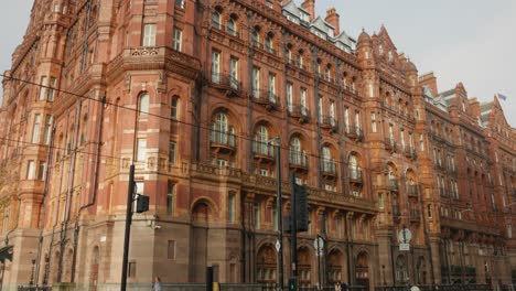 Profile-view-of-exterior-architecture-of-Midland-hotel-during-daytime-in-Manchester,-England