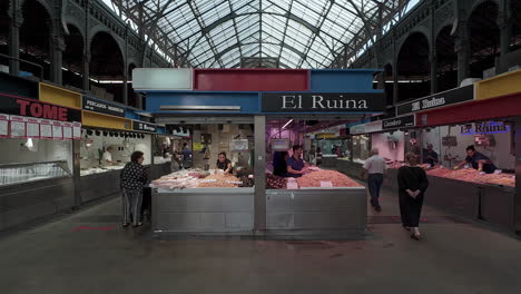 Indoor-food-market-selling-meat-and-fish,-with-shoppers-browsing---Spain-Malaga