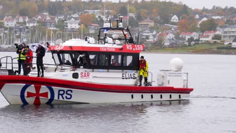 Rescue-boat-and-camera-crew-responding-to-an-emergency-in-the-harbor