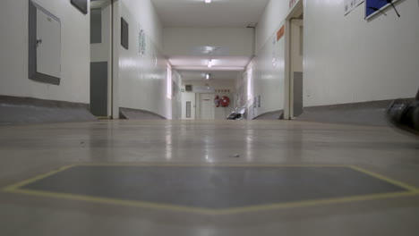 People-walk-along-an-unwashed,-dirty-corridor-floor-at-a-South-African-government-hospital-in-Gauteng