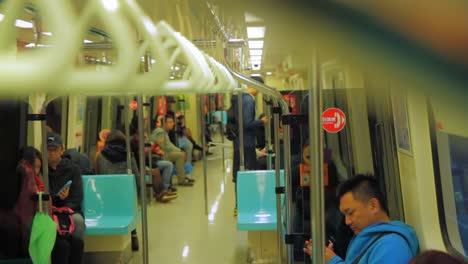 Interior-of-Taipei-metro-at-night-with-Asian-persons-getting-seated