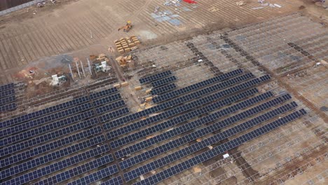 Aerial-drone-view-camera-showing-lots-and-lots-of-power-stations-and-lots-of-solar-panels