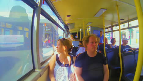 Male-female-couple-on-tour-in-hop-on-hop-off-bus-in-Rome-Italy-interior