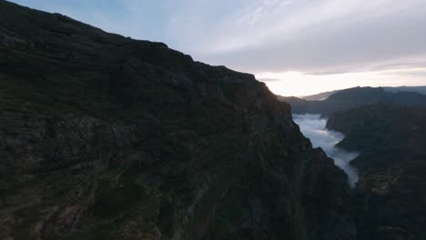 FPV-drone-diving-down-the-valley-at-Pico-do-Arieiro-in-the-mountains-at-sunset