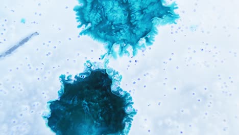 Two-shades-of-blue-ink-dispersing-in-water-with-a-cloudy-appearance-and-floating-bubbles