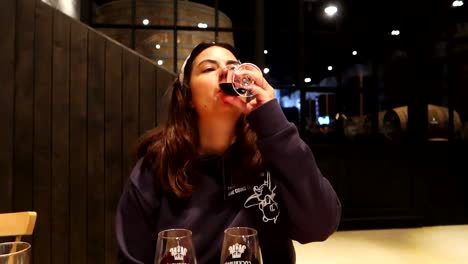 Woman-drinking-varieties-of-Porto-Wine-during-wine-tasting-in-Cockburn's-wine-cellar,-Gaia