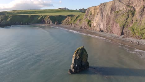 Drone-full-tide-sea-stack-and-cliffs-hidden-beach-copper-Coast-Waterford-Ireland