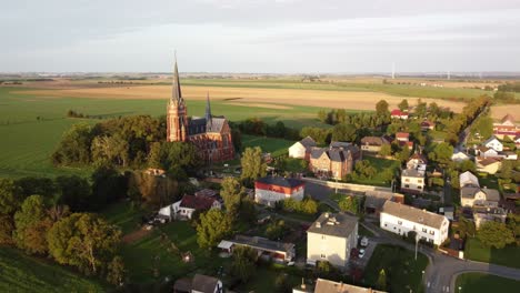 Opava-District,-Czech-Republic---The-Sight-of-the-Jana-Krtitele-Church-and-the-Surrounding-Landscape-in-Sudice-Village---Orbit-Drone-Shot