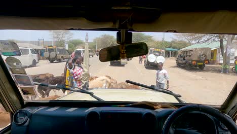 Village-People-Herding-Cows-On-The-Street-In-Maasai-Mara,-Kenya