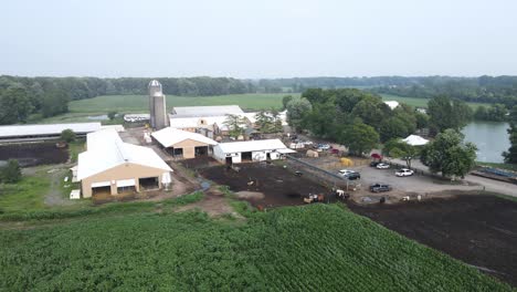 Local-dairy-farm-with-livestock-in-field-in-Michigan,-aerial-drone-view