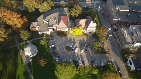 Aerial-drone-shot-looking-down-over-the-Patten-Free-Library,-moving-towards-the-Kennebec-River