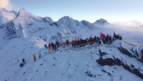 Expedition-group-reaching-the-snowy-summit-of-Mount-Siguniang-in-Sichuan,-China