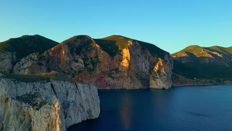 Porto-Flavia-scenic-landscape-at-sunset,-Natural-limestone-rocky-cliffs-at-the-coast-of-Masua,-South-Sardinia,-Italy