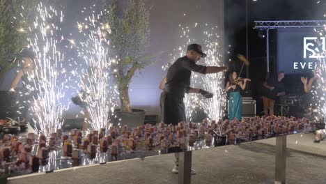 Chef-performance-preparing-snacks-for-a-party,-big-show-with-firesticks-and-dancers-in-southern-France