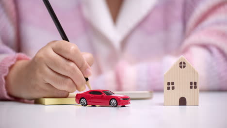 An-individual-planning-and-calculating-the-money-needed-for-a-new-car-and-house-on-a-loan
