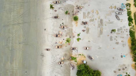Wooden-fishing-boats-on-the-beach,-aerial-top-down-view