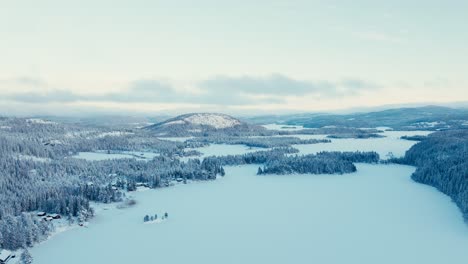 Aerial-Winter-Landscape-With-Frozen-Lake-Forest-Mountains-Near-Villages-In-Norway
