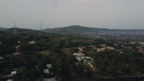 Decending-Aerial-shot-of-village-buildings-at-Akosombo-Atimpoku,-Eastern-Region