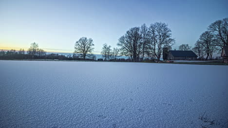 Sunset-over-a-winter-landscape-with-a-large-snow-covered-meadow