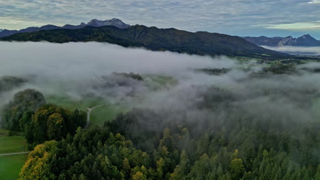 Aerial-view-of-the-mountainous-area-with-mist-shrouded-forests-around-the-Austrian-Attersee