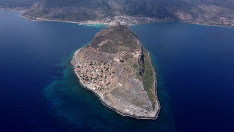 Panoramic-drone-shot-of-Monemvasia-town-at-the-east-coast-of-the-Peloponnese-surrounded-by-Myrtoan-Sea,-Greece