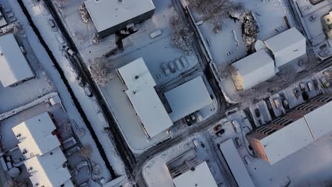 Rivers-and-houses-in-the-city-covered-with-thick-snow,-aerial-top-down