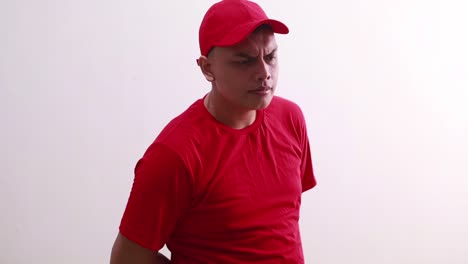 Junger-Asiatischer-Mann-In-Rot-Steht-Mit-Neugierigem-Gesichtsausdruck