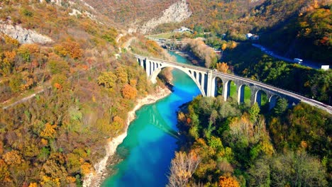Stunning-aerial-4K-drone-footage-of-Solkan-arch-bridge-over-the-Soča-river,-a-majestic-stone-marvel-located-in-western-Slovenia