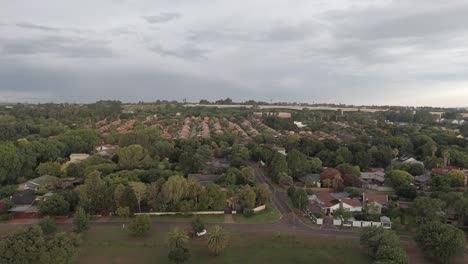 Aerial-4k-drone-flight-over-a-residential-area-with-a-train-bridge-in-the-distant-background-in-South-Africa