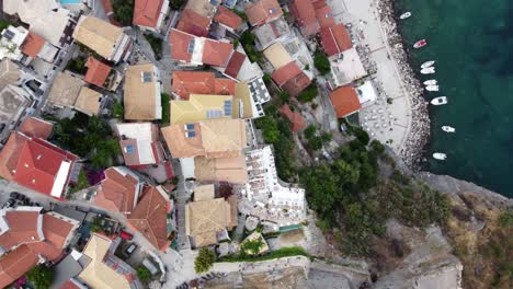 Epic-drone-shot-reveals-Parga-seaside-town-and-landscape,-Greece