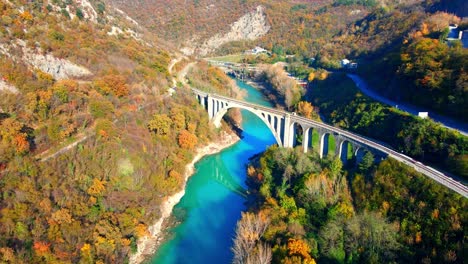 Stunning-aerial-4K-drone-footage-of-Solkan-arch-bridge-over-the-Soča-river,-a-majestic-stone-marvel-located-in-western-Slovenia