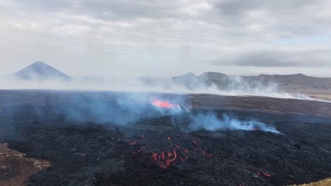 Fagradalsfjall-volcano-eruption-in-Iceland-with-rising-smoke,-aerial-drone-view