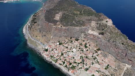 Drone-shot-of-Monemvasia-village-houses-in-Greece-surrounded-by-sea