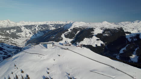 Ski-Chair-Lift-In-Ski-Resort,-Saalbach-Hinterglemm,-Austria---Aerial-Drone-Shot