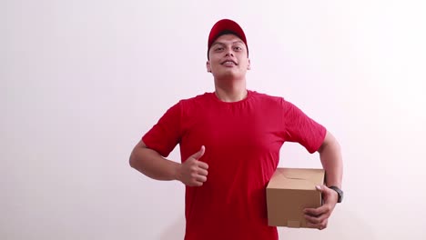 Shocked-surprised-Young-asian-courier-man-received-cardboard-and-showing-thumbs-up