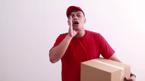 Young-asian-courier-man-shouting-calling-while-holding-cardboard