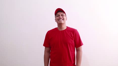 Young-handsome-asian-man-in-red-standing-while-laughing