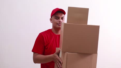 Young-asian-deliveryman-standing-while-holding-cardboard-box