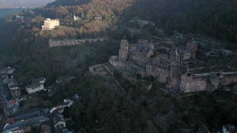Aerial-view-of-a-majestic-and-historic-castle-in-Heidelberg,-Germany,-overlooking-a-village