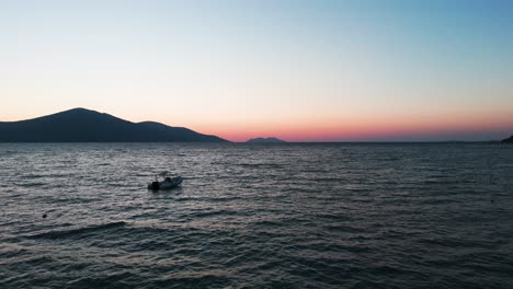 Costa-Del-Mar-Adriático-Albanés-Con-Barco-Vacío-Flotando,-Colorida-Hora-Dorada