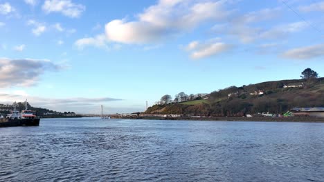 Commuter-train-arriving-in-Waterford-City-along-the-banks-of-The-Suir-River-with-an-incoming-tide