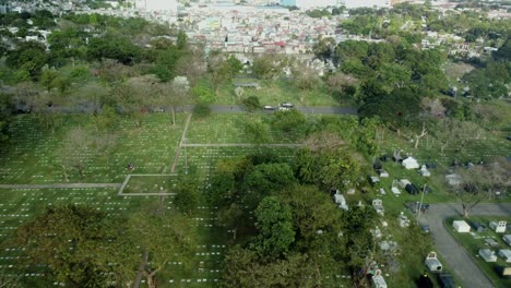 Drohnenaufnahme-Eines-Leeren-Friedhofs-Mit-Vorbeifahrenden-Autos-Auf-Den-Philippinen