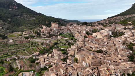 Traditional-village-of-Valldemossa-on-the-Tramuntana-mountain,-Mallorca,-Balearic-Islands,-Spain-drone-shot