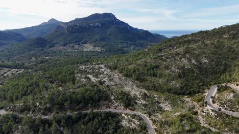 Drone-shot-of-snakes-road-and-landscape-in-the-Esporles-valley-on-the-island-of-Mallorca-in-the-Serra-de-Tramuntana,-Spain