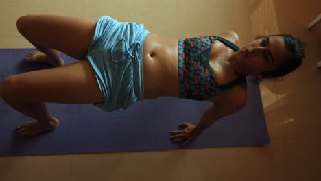 Top-shot-of-young-Indian-woman-doing-yoga-in-her-room